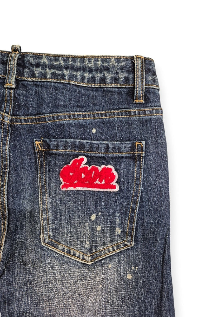 Jeans da ragazzo a cinque tasche con strappi e schizzi con logo lettering laterale IBDT00716